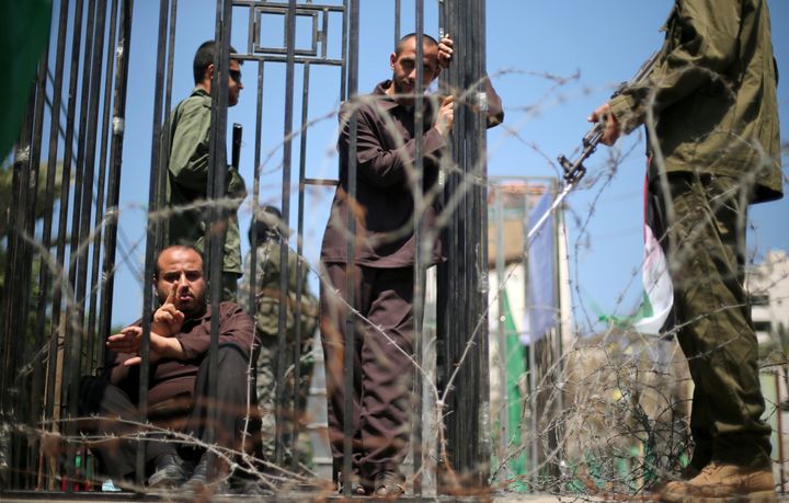 Men play the role of jailed Palestinians and Israeli soldiers during a rally in support of Palestinian prisoners on hunger strike in Israeli jails, in Gaza City April 17, 2017.
