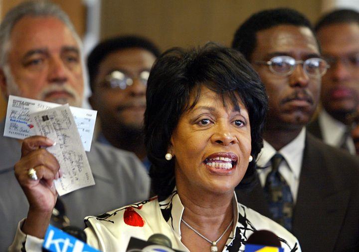 Rep. Maxine Waters displays checks to be placed in a legal defense fund for Mitchell Crooks, who videotaped the 2002 police beating of 16-year-old Donovan Jackson and was arrested on outstanding warrants.