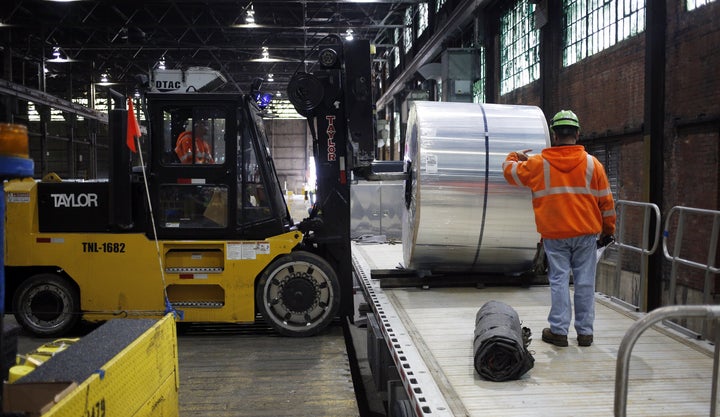 Workers load an aluminum coil onto a loading dock at the Arconic Inc. manufacturing facility in Alcoa, Tennessee, U.S., on Tuesday, Jan. 24, 2017.