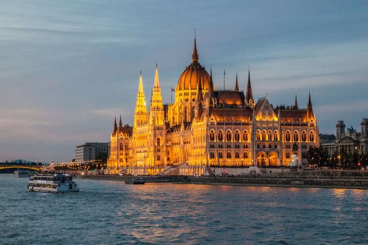 The House of Parliament, fronting the Danube River in Budapest, Hungary, seems every bit the fairy castle when seen at sunset from the deck of the Scenic Pearl. Budapest, Hungary.