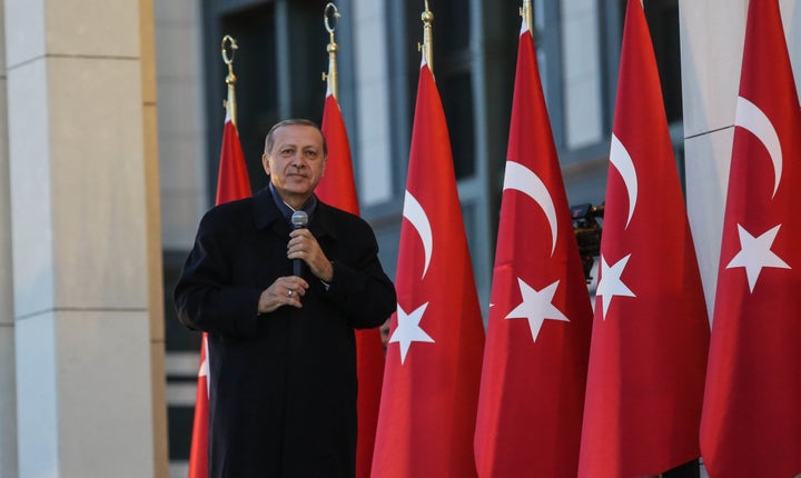 Turkish President Tayyip Erdogan gives a referendum victory speech to his supporters at the Presidential Palace on April 17,