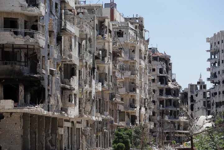 Three years later, in 2014, an image shows destroyed buildings in the Homs neighborhood of Khaldiyeh, formerly held by rebel fighters and later captured by Syrian government forces faithful to Bashar al-Assad.