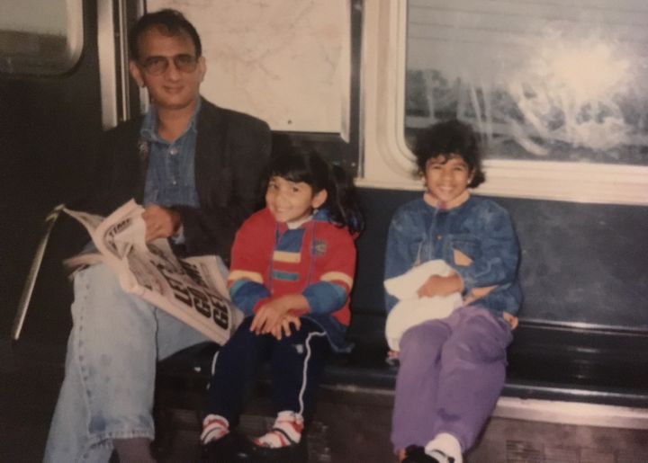My father, sister, and I riding the New York subway.