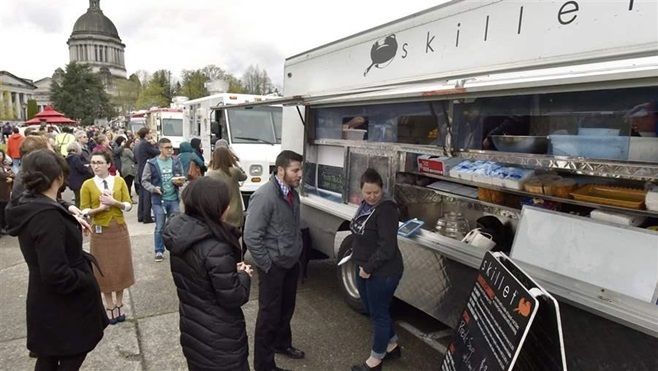 Customers line up at food trucks near the Washington state capitol. Washington is among a handful of states to establish some uniform regulations governing the mobile vendors.