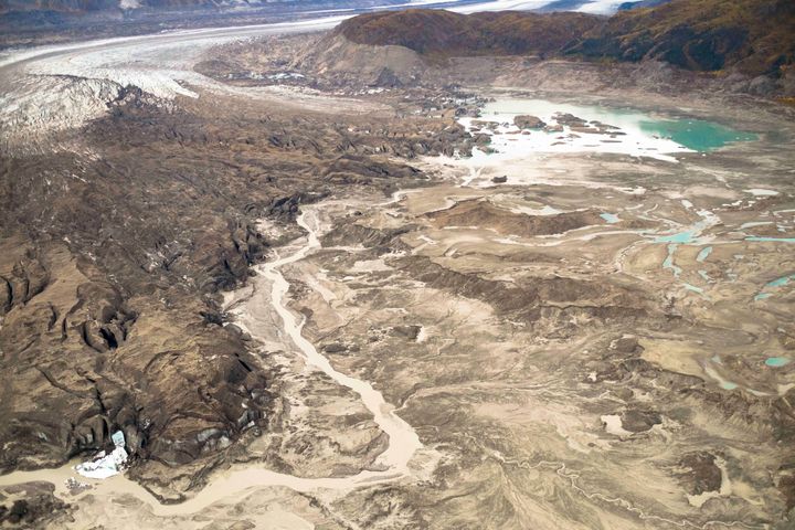 Photo shows the meltwater stream along the toe of Kaskawulsh Glacier seen on the left that is diverting fresh water from one river to the other.