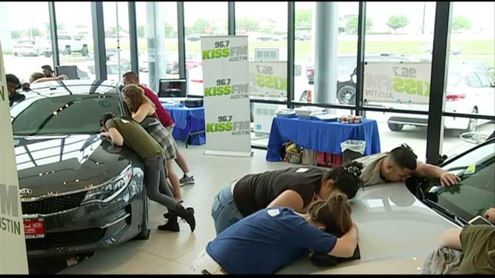Nearly two dozen people entered a kissing competition in a bid to win a free Kia.