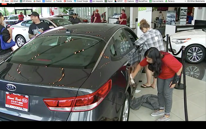 A contestant tries to wipe away smudges left by another contestant on the side of a car during a 10 minute break.