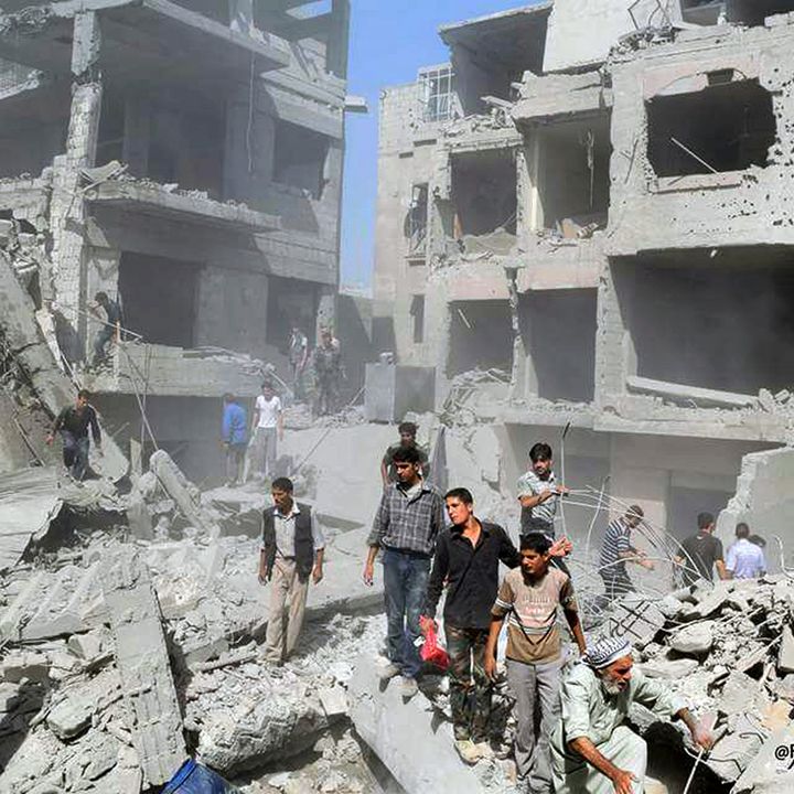 <p><em>This photo released by the Douma Revolution News Network on their Facebook page, shows Syrians looking for bodies under debris of destroyed buildings following a Syrian</em> <em>government </em>a<em>irstrike on the Damascus suburb of Douma, Syria, Saturday, Aug. 22, 2015</em> </p>