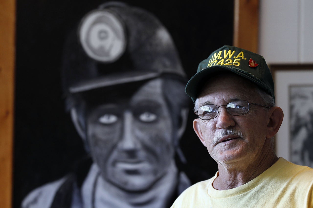 Carl Shoupe stands by a painting of a coal miner in the Kentucky Coal Mining Museum in Benham, Kentucky, in 2011.