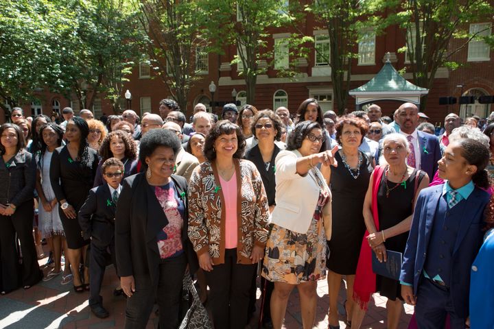 A crowd of descendants of slaves sold by Georgetown University in 1838 gathers for a group photo in front of Isaac Hawkins hall at the conclusion of a dedication of it and Anne Marie Becraft hall at Georgetown University on the campus, in Washington D.C., Tuesday, April 18, 2017. 
