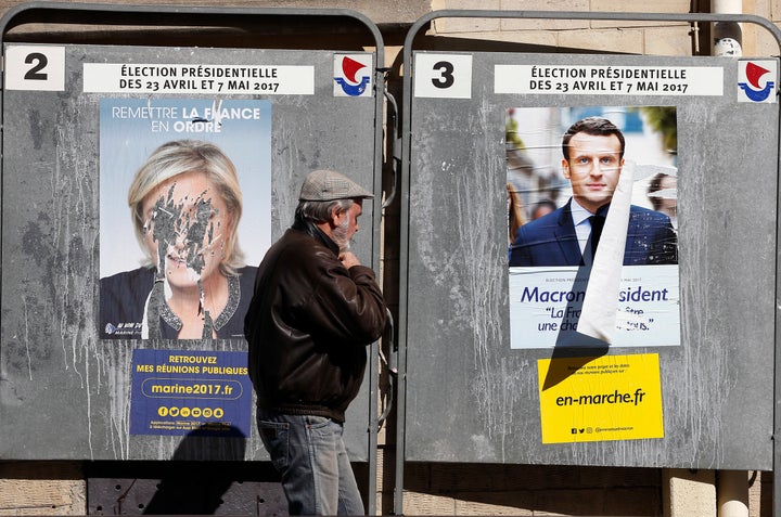 Official campaign posters showing Le Pen and Emmanuel Macron in Paris. 