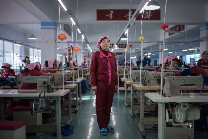 In this photo taken on Feb. 18, 2017, Pak Song Hyang, 30, stands between sewing machines at a facility described to AFP as the "Pyongyang bag factory" in Pyongyang.