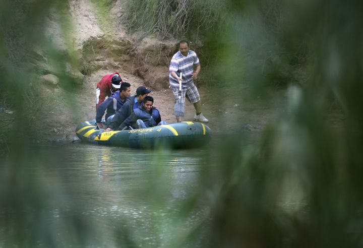 Undocumented immigrants cross the Rio Grande from Mexico into the U.S. near McAllen, Texas on Jan. 4.