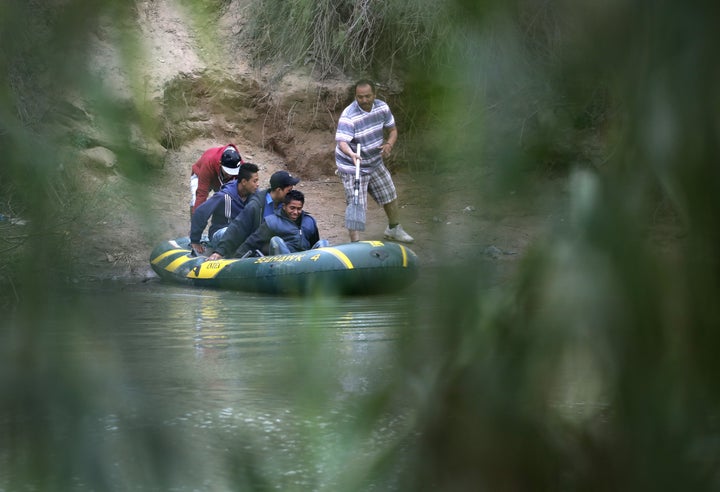 Undocumented immigrants cross the Rio Grande from Mexico into the U.S. near McAllen, Texas on Jan. 4.