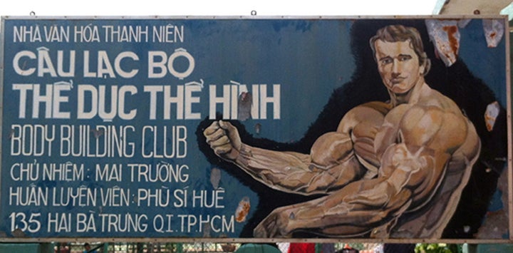 A hand-painted folk portrait of Arnold Schwarzenegger advertising a Ho Chi Minh City bodybuilding gym, photographed in 2011.