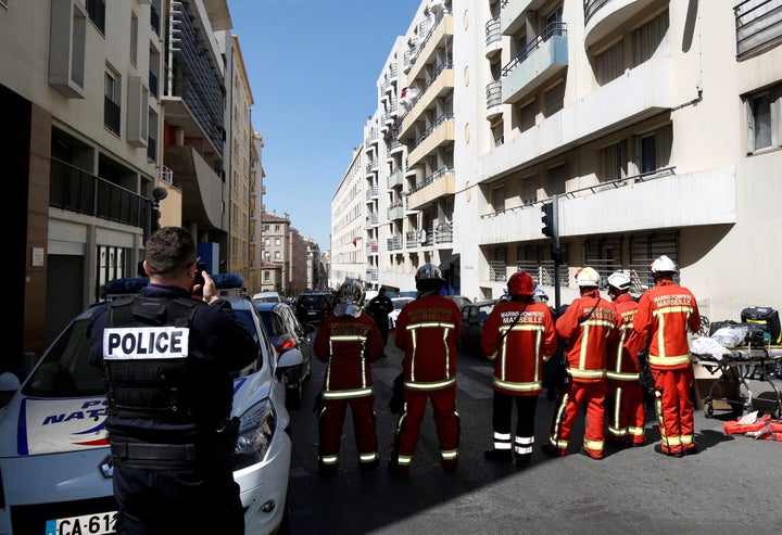 French firefighters block the street as police conduct an investigation after two men were arrested in Marseille on April 18. Police say the men planned a "violent attack" before the eleciton.