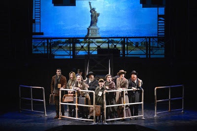 New immigrants arrive at Ellis Island at the beginning of Rags