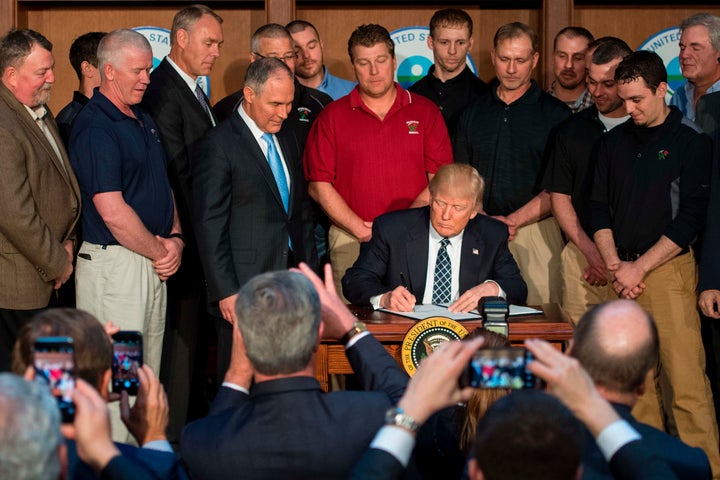 Surrounded by miners from Rosebud Mining, Trump signs the Energy Independence Executive Order at EPA Headquarters in Washington, DC, March 28, 2017.