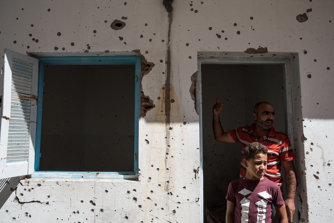 Extremism is no stranger to Tunisia. Here, two Tunisians visit a house damaged during a shootout between the army and suspected terrorists in their hometown.