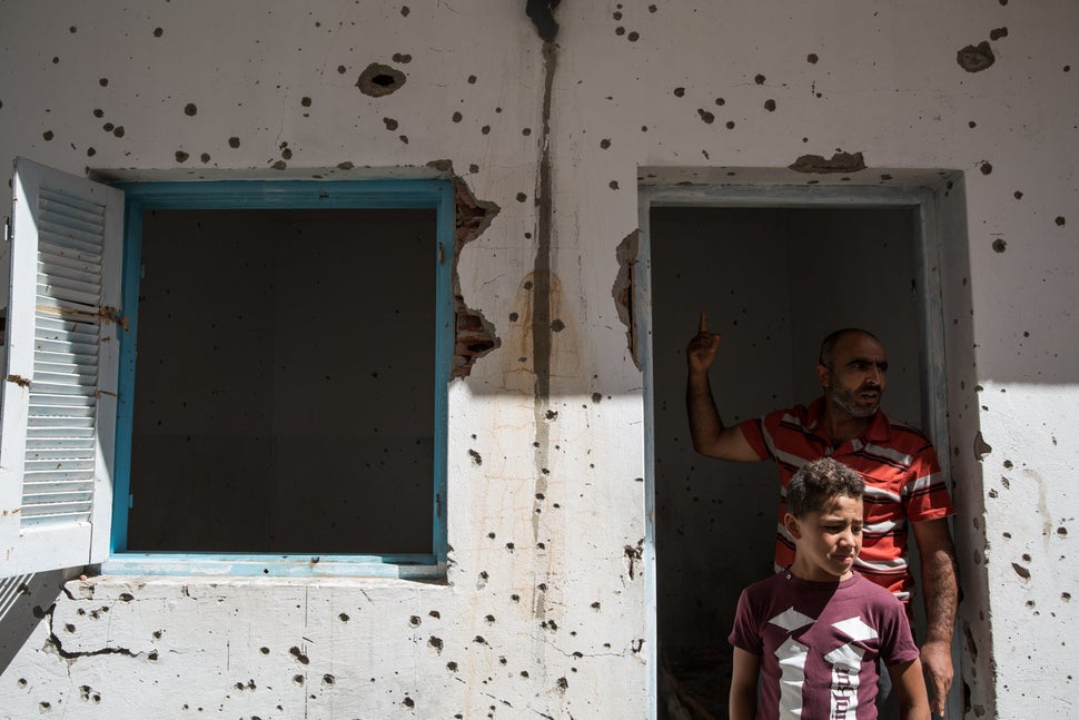 Extremism is no stranger to Tunisia. Here, two Tunisians visit a house damaged during a shootout between the army and suspect