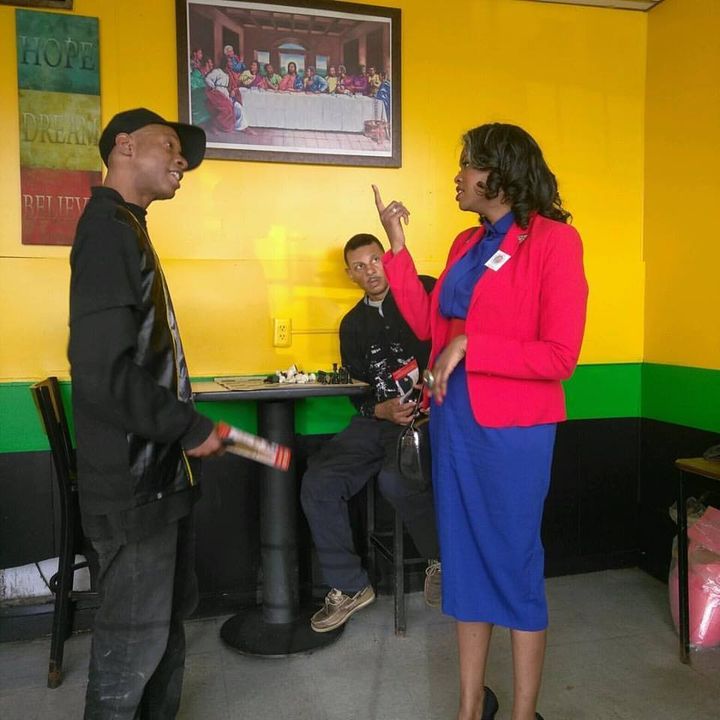 Candidate discusses policy proposals with Detroit citizens — at Caribbean Citchen. 