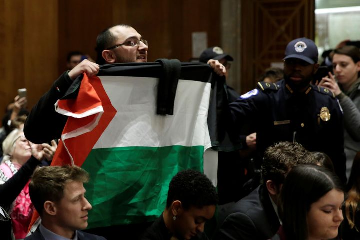 Taher Herzallah holding a Palestinian flag during David Friedman's confirmation hearing, Feb. 16, 2017.