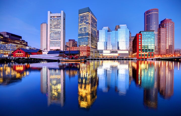 Boston downtown skyline refection on the harbor waterfront from the Fort Point neighborhood