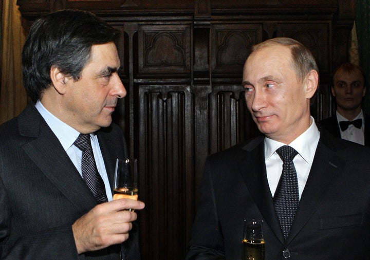 Russian Prime Minister Vladimir Putin (R) and Francois Fillon speak in a restaurant in Moscow, late on Dec. 8, 2010.