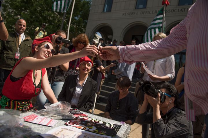 Volunteers with DCMJ hand out joints during the 1st Annual Congressional Joint Session pot giveaway to credentialed Hill staff and the media near the Capitol on April 20, 2017.