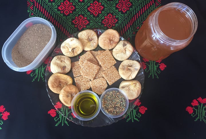 Some food from Palestine: Top left - spice mix used for chicken. Plate - dried figs, sesame and and honey sweets, olive oil