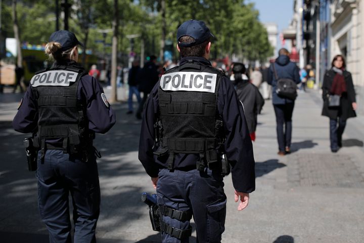 French police patrol the Champs Elysées Avenue the day after the attack.