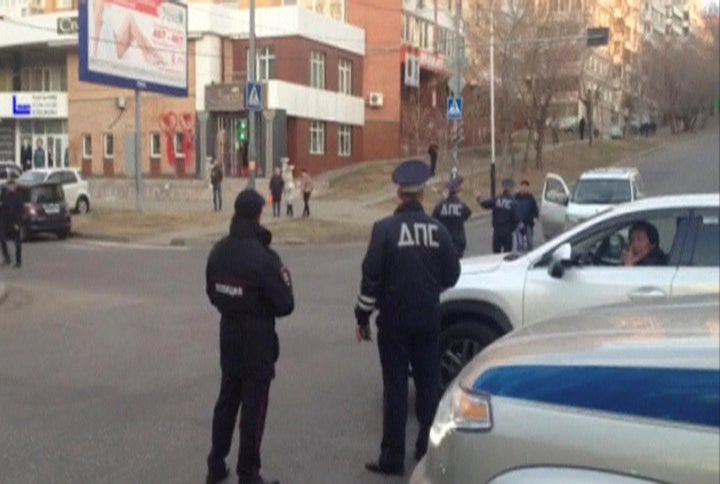 A still image from a video footage shows Interior Ministry officers block a street near a regional office of Russia's Federal