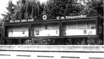 This sign hung on the bridge over the river Wurm in 1933 in Geilenkirchen and was located about 70 meters from my grandmother's childhood home. The headline states: “Wer beim Juden kauft ist ein Volksverräter” (He who buys at Jew [=Jewish shop] is a traitor against the people)." 