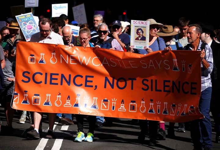 Protesters hold placards and banners as they participate in Saturday's March for Science rally on Earth Day, in central Sydney, Australia.