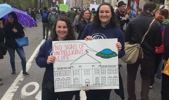 Demonstrator Rachel Misner (right) shows off her sign with friend, Sarah. 