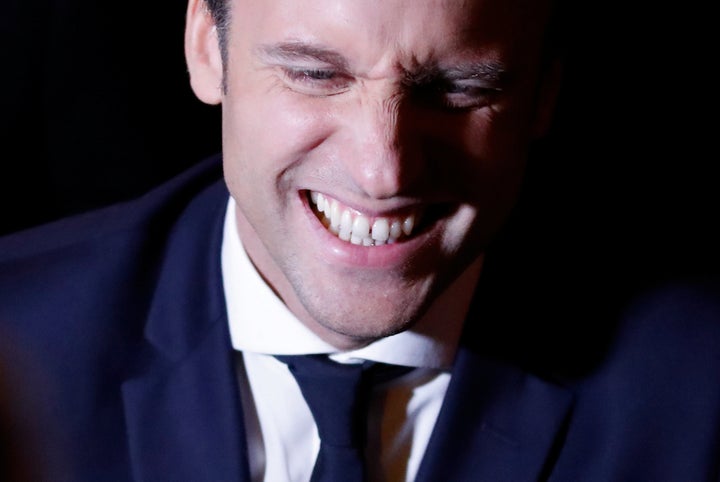 Emmanuel Macron smiles at his campaign headquarters. 