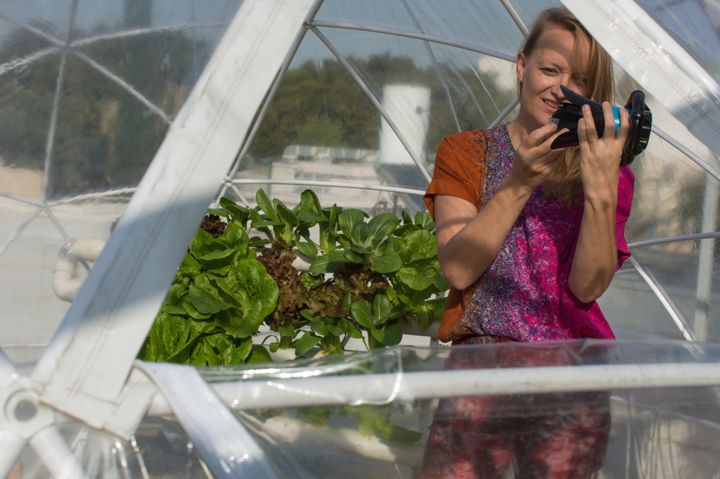 <p>Karin Kloosterman holding Eddy in her Middle Eastern year-round garden. Image via Bloomberg.</p>