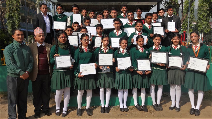 <em>Nepalese teacher Baman Kumar Ghimire (far left) stands with students who completed their first online course.</em>