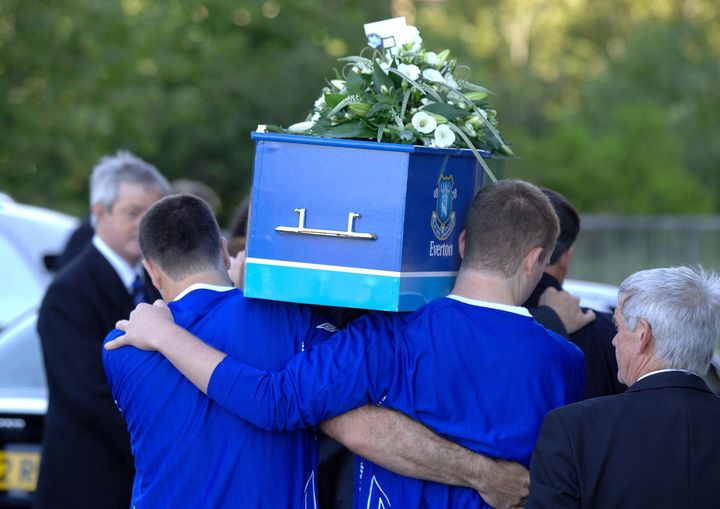 His pallbearers included his father (left) and brother Owen (right), both of whom wore Everton shirts