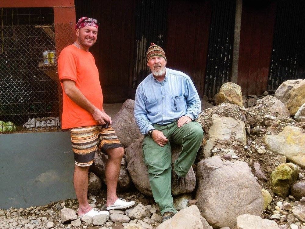 Tom Hewitt (left), director of travel company Adventure Alternative Borneo, captured a photograph of what was believed to be a New Guinea wild dog in 2012. The photo was too blurry to be conclusive, however. James "Mac" McIntyre (right) ultimately captured more than 100 photos of the animal in the wild in 2016.