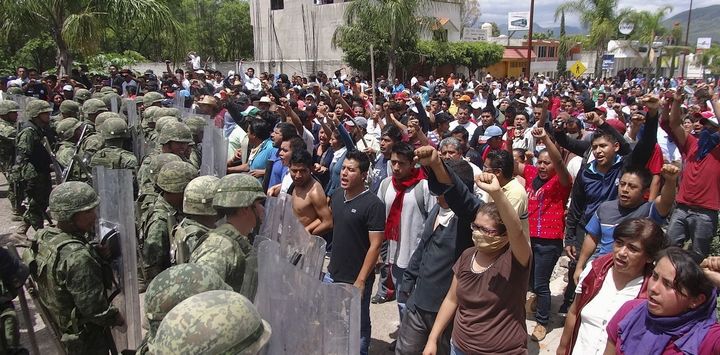 Mexican protesters confront the marines sent in to disband them. 