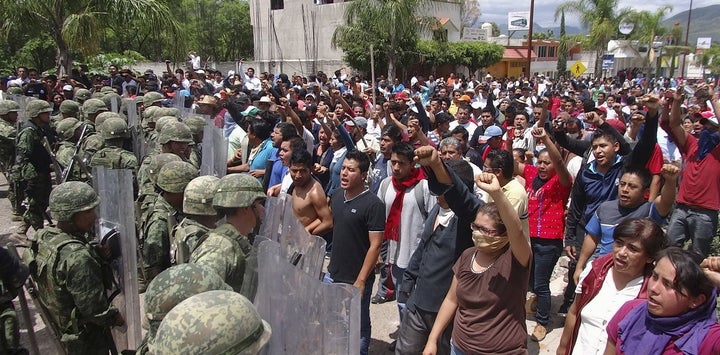 Mexican protesters confront the marines sent in to disband them.
