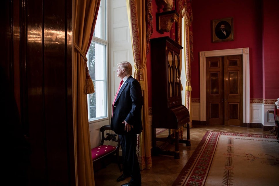 President Donald Trump looks out of the Red Room window onto the South Portico of the White House grounds on Jan. 20, 2017, b
