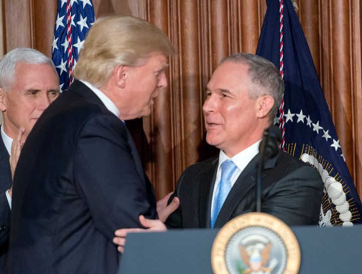 President Donald Trump, left, is greeted by Environmental Protection Agency Administrator Scott Pruitt, right, prior to signing an Energy Independence Executive Order on March 28, 2017. The order reverses the Obama-era climate change policies.