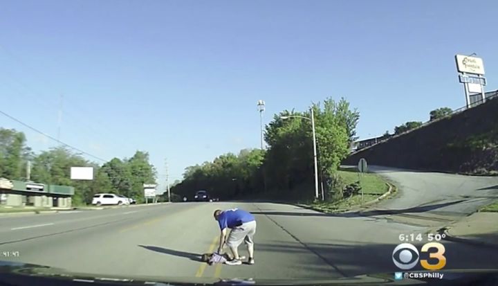 A volunteer firefighter is seen coming to the rescue of a 4-year-old girl after she fell from a bus.