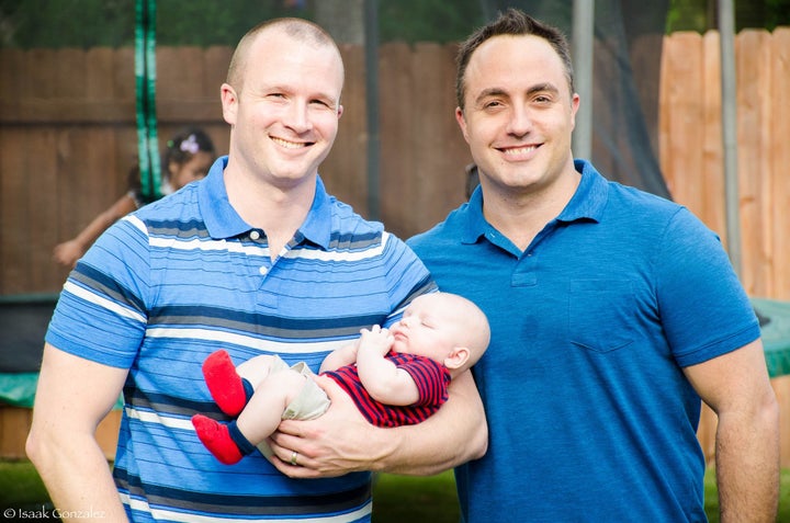 Burke holding Caleb with Justin