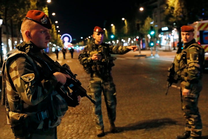 French soldiers stand guard on the Champs Elysees in Paris after a shooting on April 20, 2017.