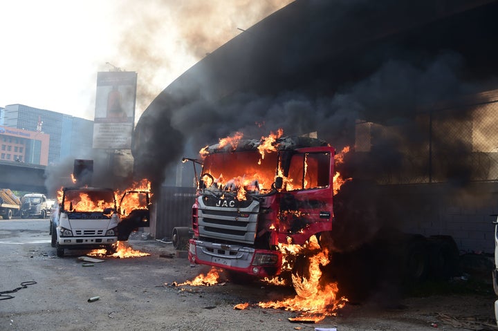 Trucks burn in flames during a demonstration by Venezuelan opposition activists against President Nicolas Maduro in Caracas.&