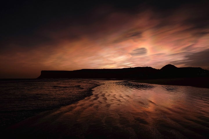 Nacreous clouds visible over cliffs on February 02, 2016 in Saltburn-by-the-Sea, England.