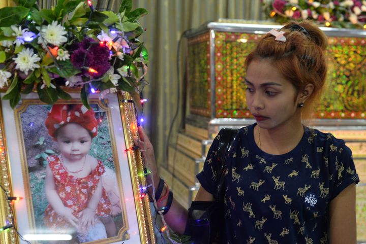 Jiranuch Trirat, mother of 11-month-old daughter who was killed by her father who broadcast the murder on Facebook, stands next to a picture of her daughter at a temple in Phuket, Thailand April 25, 2017.